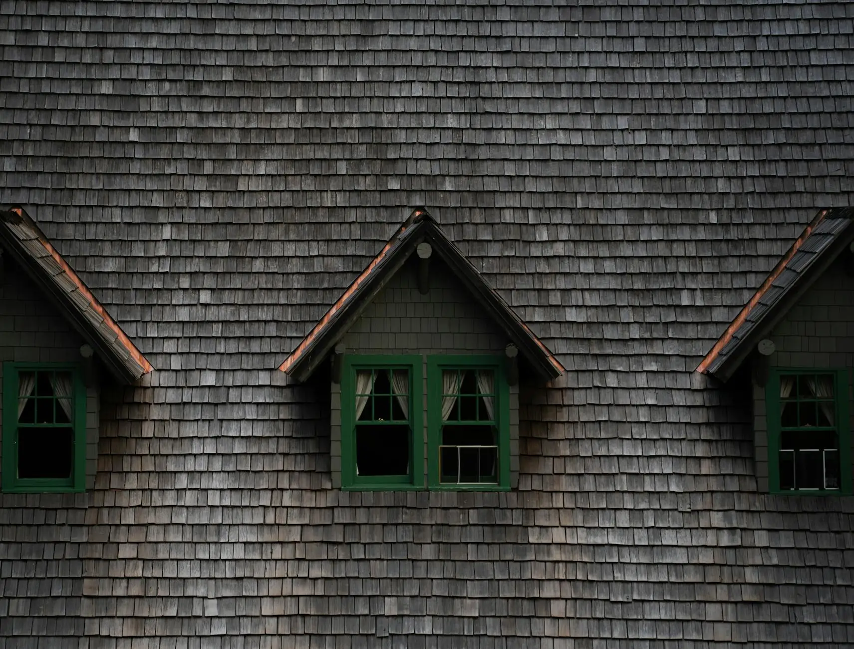 A close-up of a high-quality architectural shingle roof installation with clean ridge vents and flawless flashing.